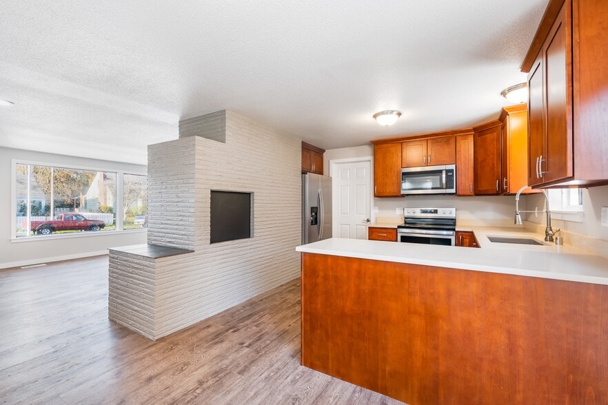 Kitchen with stainless steel appliances and quartz tops - 6235 A St