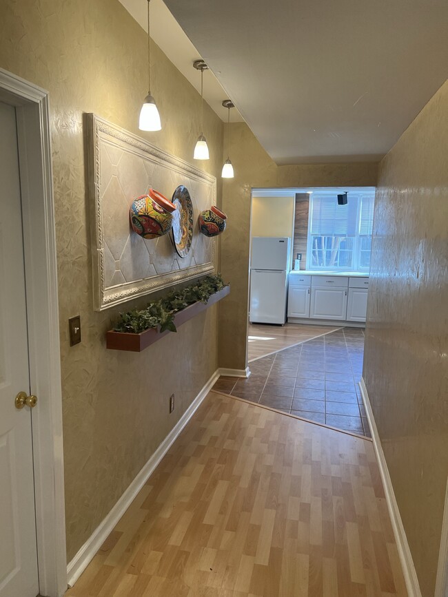 Hallway from kitchen and living room leading to bedrooms and laundry room. - 3617 Sunset Rdg