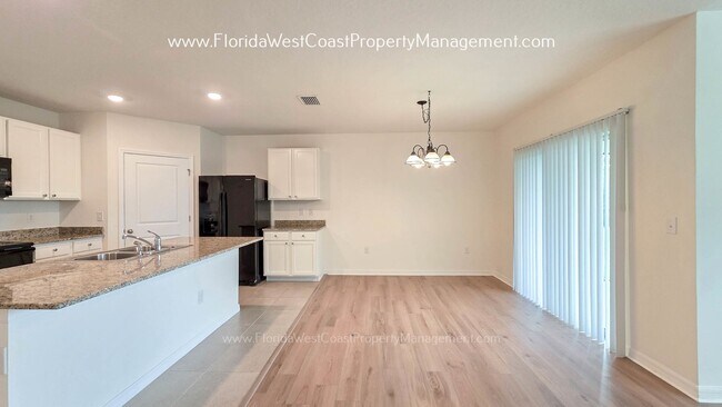 Building Photo - MOVE IN READY ! 4 BEDROOM/2 BATH! TILE- LVP THROUGHOUT! LAWN MOWING INCLUDED!