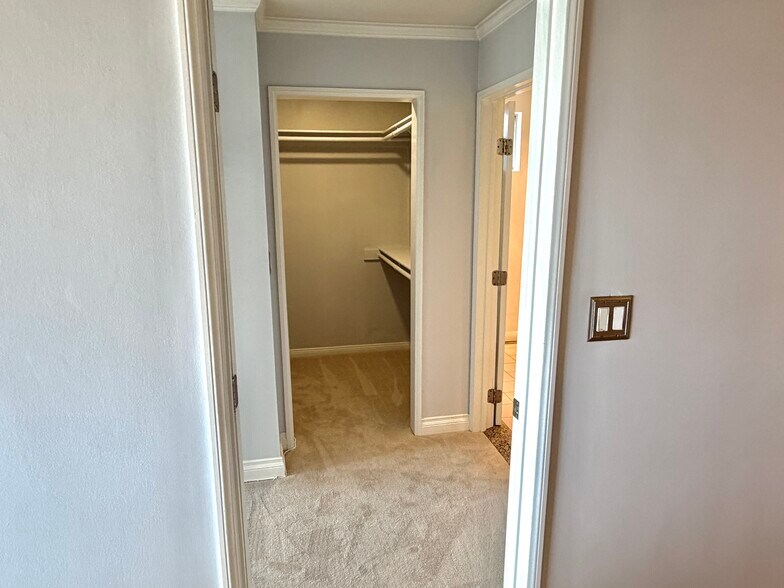 View leaving the kitchen and entering the bedroom with walk in closet view - 1649 Appian Way