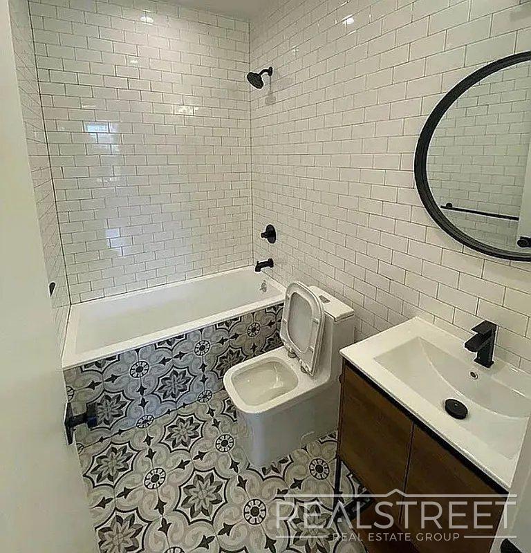 Building Photo - Bright & Renovated 2-Bedroom Apartment with Modern Amenities and Roof Access