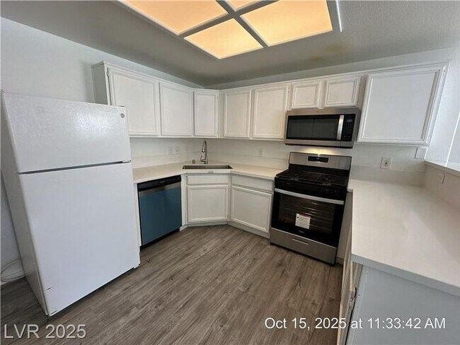 Building Photo - SPACIOUS FIRST-FLOOR CONDO LOCATED IN A GA...