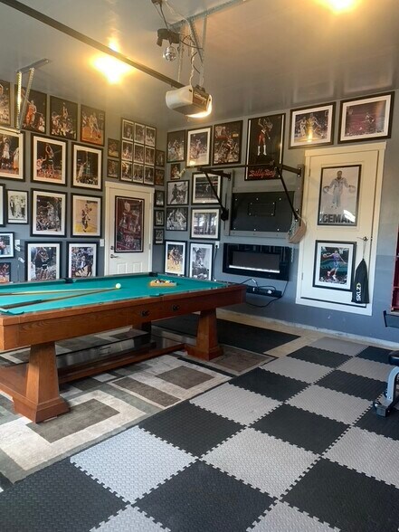 Pool table and workout area in the garage - 5401 NE 66th Dr