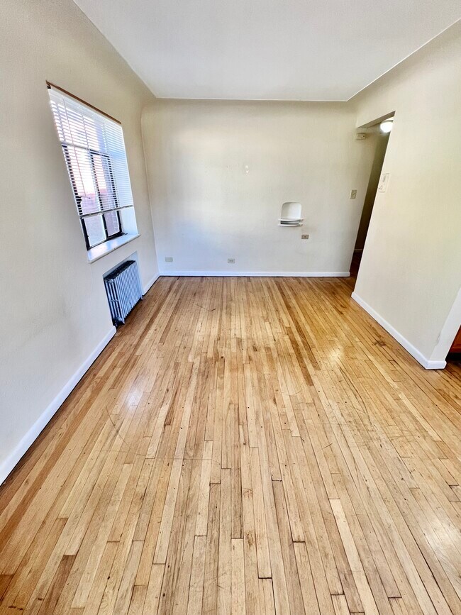Experience the warmth of this inviting space with gleaming hardwood floors and abundant natural light. - Hillside Apartments