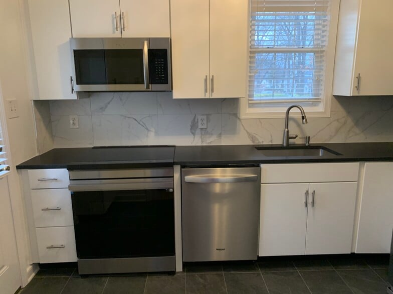kitchen with new cabinets and granite countertop - 4817 Park Ave