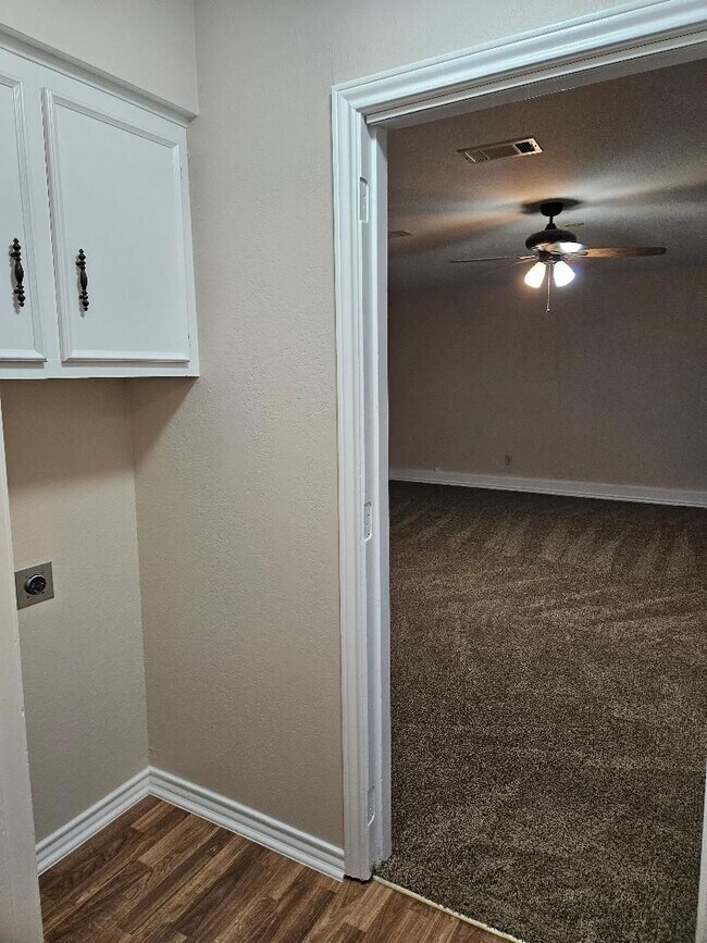 Building Photo - Three bedroom and two bathroom nicely remodeled with new flooring. Large wood fenced backyard