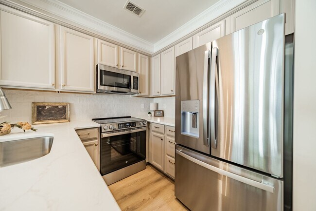 Building Photo - UPGRADES! Two Bedroom Townhouse - Six Mont...