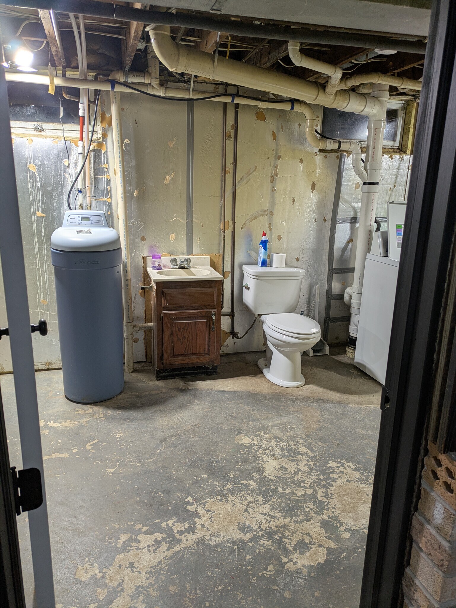 Bathroom off lower living room. Cabinet, toilet, & water softener have been replaced since picture. - 2222 Diagonal Rd