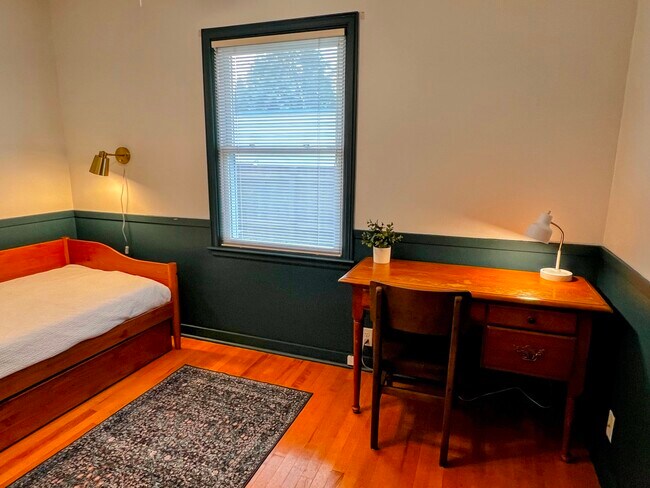 Work from home at a sturdy vintage desk with natural light. - 228 W Lexington Blvd