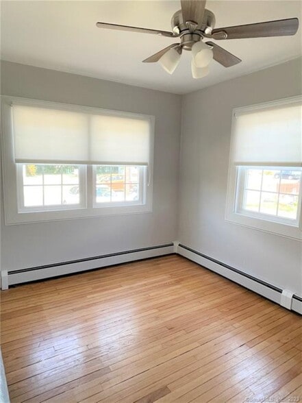 Home office or playroom offers beautiful light, custom shades and a door for privacy - 10 Treadwell St