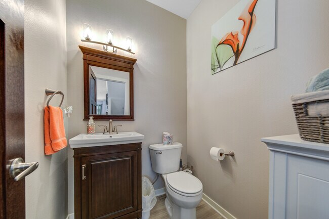Half bath on main level with tile and vanity /sink. - 2163 Rolling Green Ln