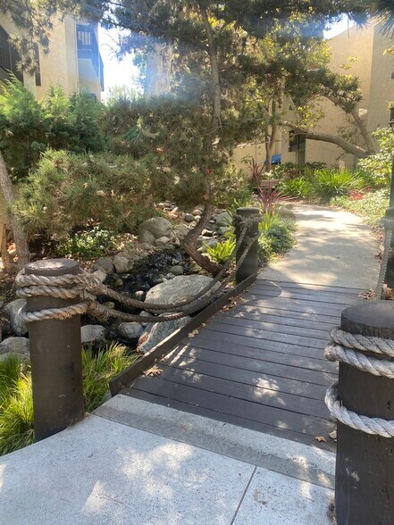 Landscaped bridge crossing one of the community streams - 8305 Summertime Ln
