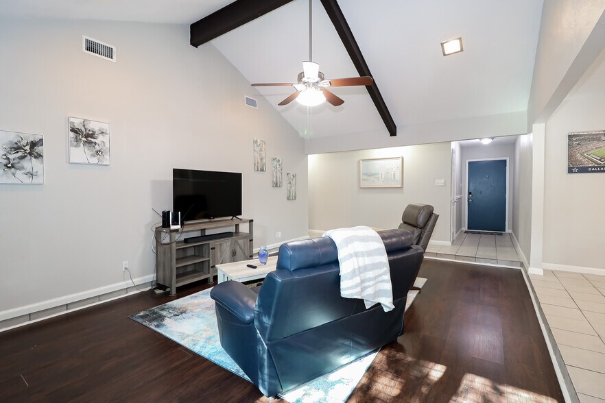 The living room features a new 55" Roku TV and sound bar. There is also a wood-burning fireplace. - 2507 Holt Road