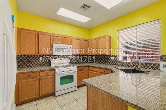 Building Photo - NW!! 4 Bedrooms!!! All Tile and Pergo flooring T/O!! NO Carpet!!! Low Maintenance Desert landscap...