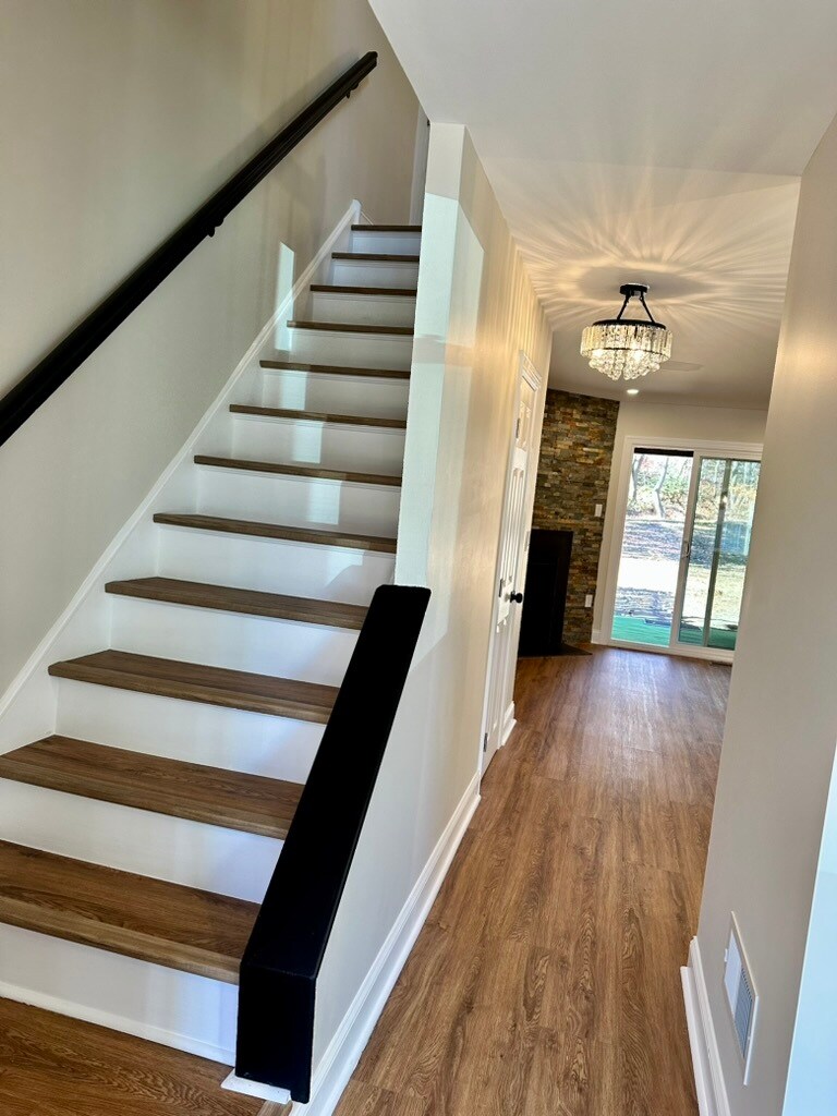 Elegant wood staircase connecting living and bedroom levels—enhancing the home’s character and creat - 55 Providence Ave