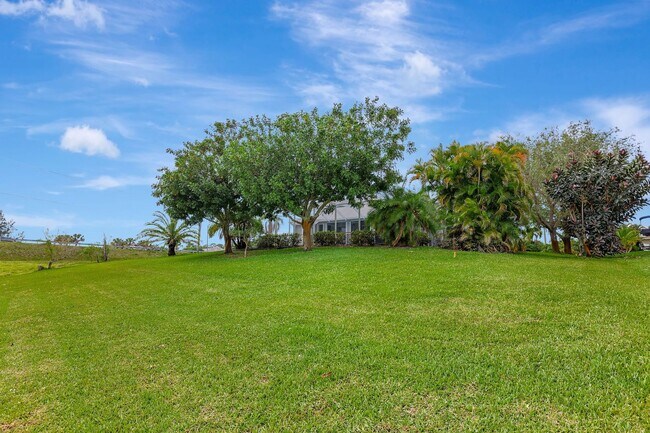 Building Photo - A BOATER'S PARADISE WITH THIS STUNNING 3 BEDROOM, 2 BATH WATERFRONT POOL HOME W/DOCK & BOAT LIFT ...