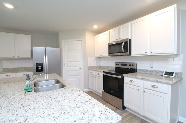 Building Photo - Coming Available Soon – 4BR/2BA Brick Home with Open Floor Plan, Solar Panels & 2-Car Garage in L...