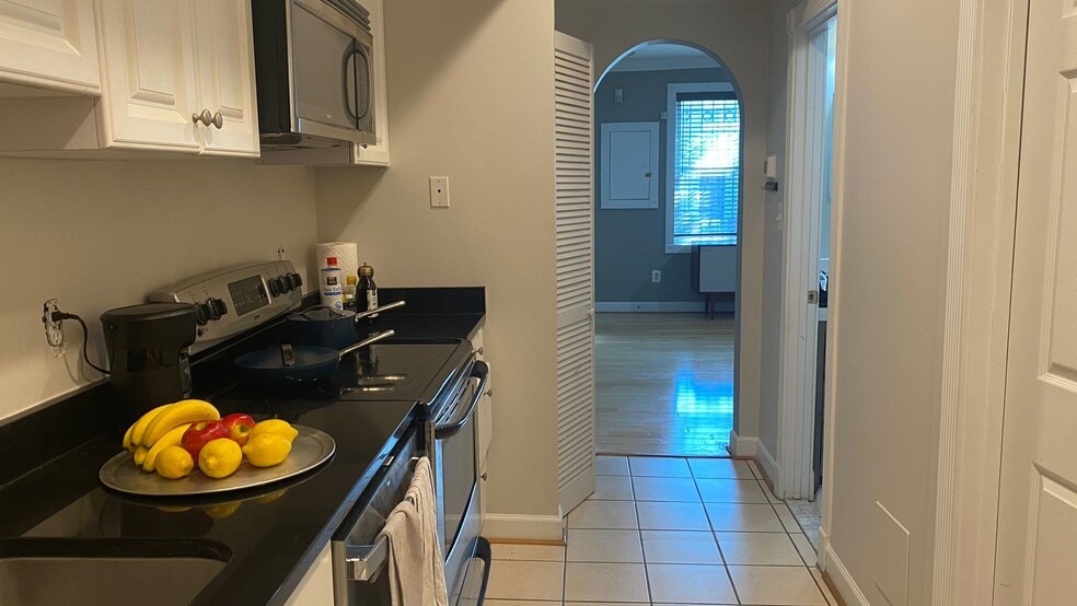 Galley kitchen with dishwasher and flat-top stove - 1242 Queen St, NE