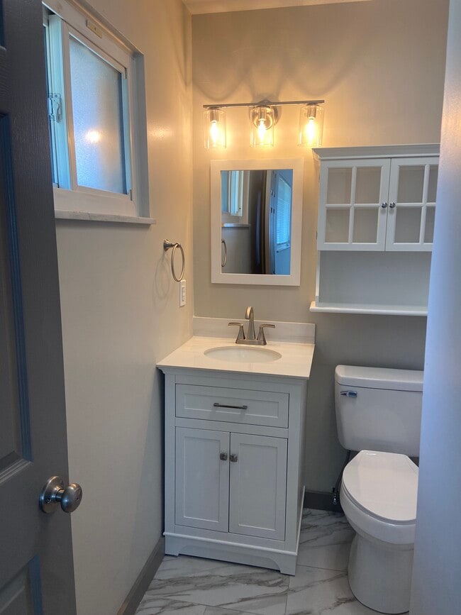 Owners' Suite en-suite bathroom with new vanity, toilet, lights, blue tooth exhaust fan, and storage - 174 Brisbane Ave