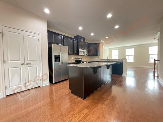 Building Photo - Beautiful 3 Story 3 Bedroom Townhouse with Huge 1st Floor Flex Space with Access to Patio + 2 Car...