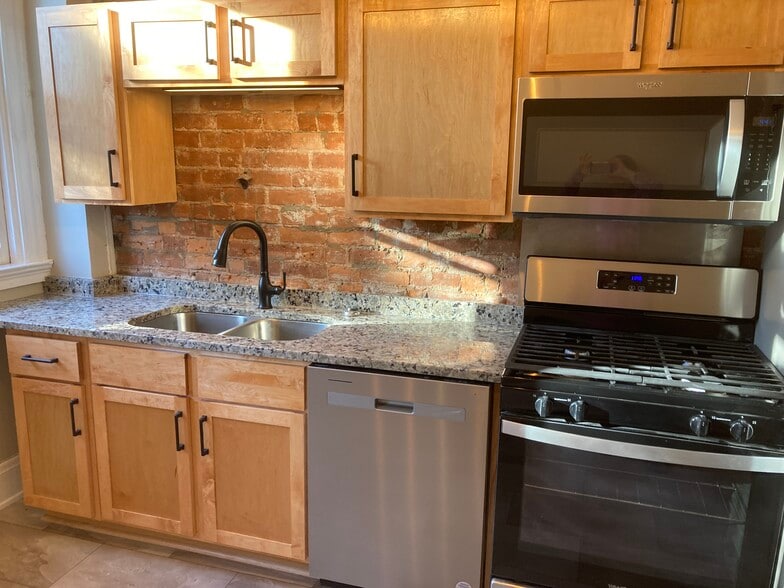 Kitchen has new dishwasher, stove, microwave and fridge with ice maker. - 2221 Oakland Ave, Apt A