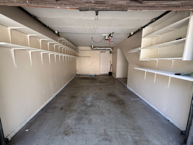 Attached garage with built-in shelving for extra storage - 1134 W Huntington Dr