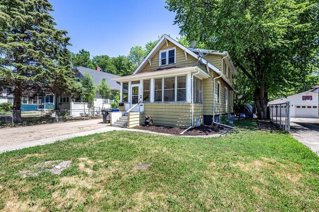 Front of House with porch included for Middle unit - 1027 University Dr N