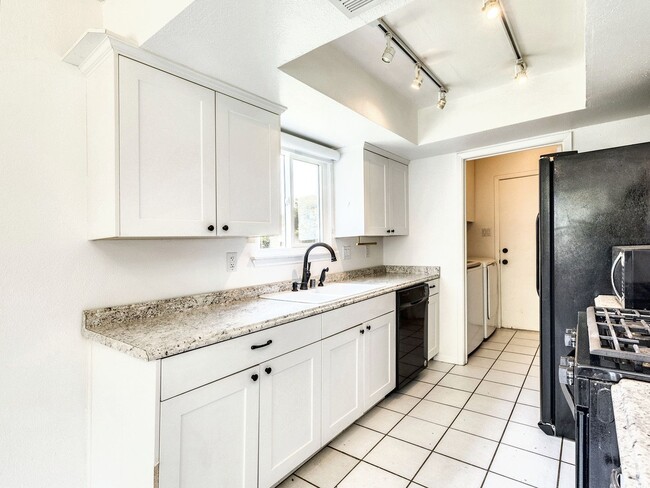 Building Photo - Charming 4BR / 2BA Home Featuring Fireplace, White Cabinets & Big Tree