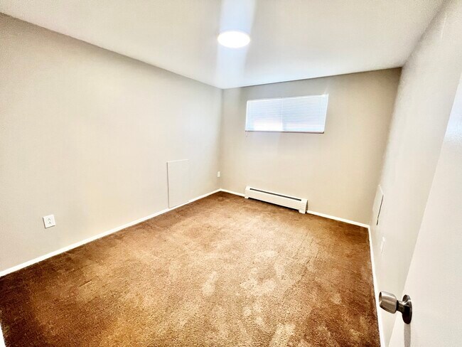 Experience comfort in this well-lit space, perfect for relaxation. - Westland Apartments