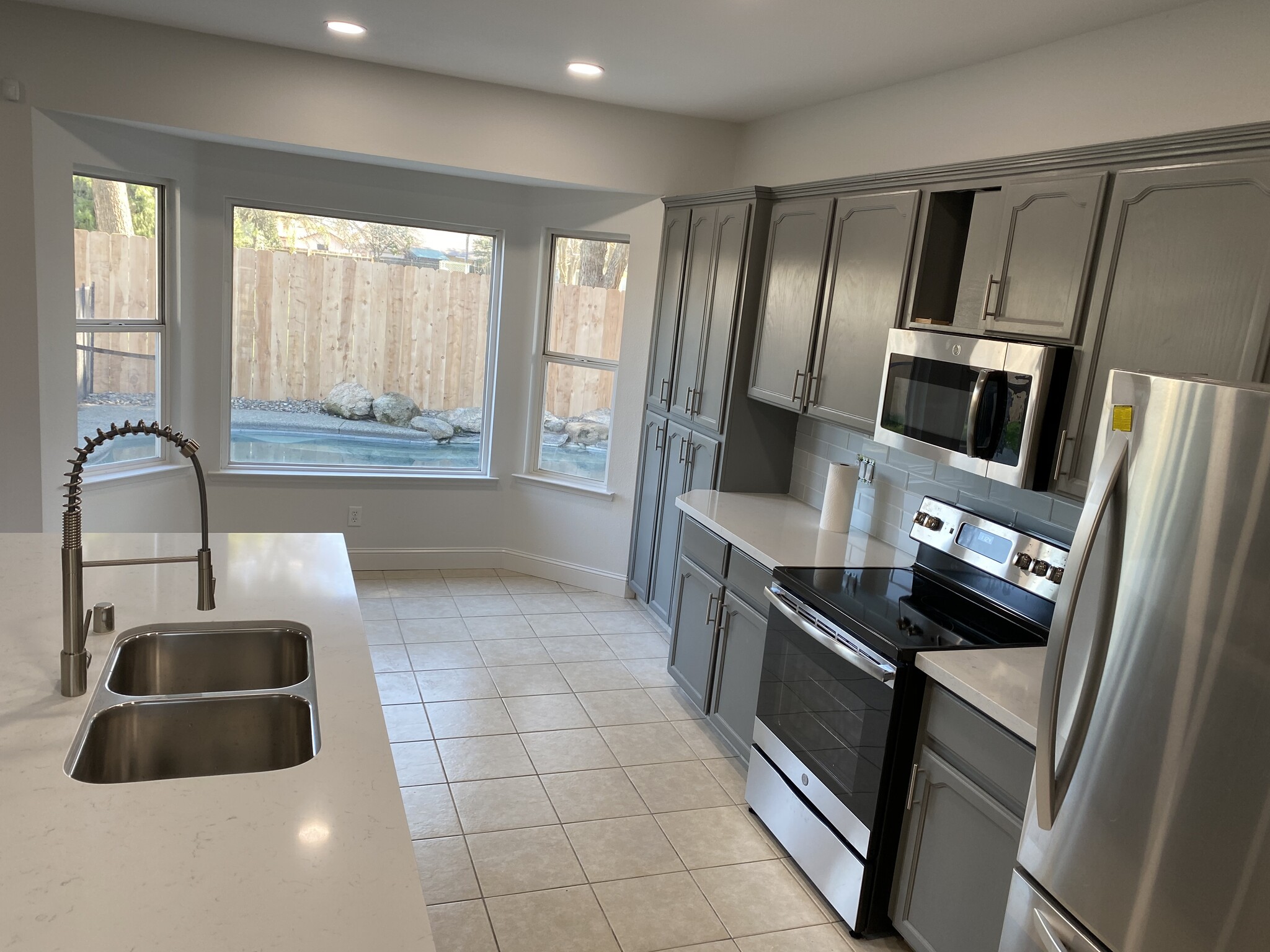 kitchen; view to the pool. Renovation in progress! - 1134 Pine Ct