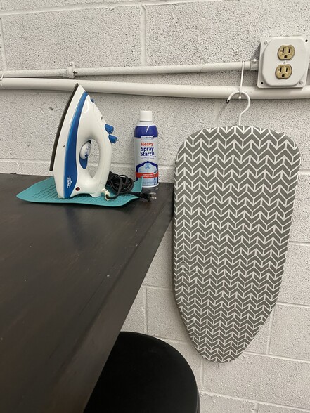 Iron and ironing board provided in laundry facility. - 475 S Hickory St