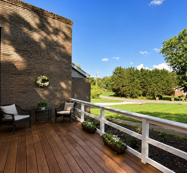 Private front deck with seating—perfect for enjoying your morning coffee or relaxing outdoors. - 1115 Henrietta Dr