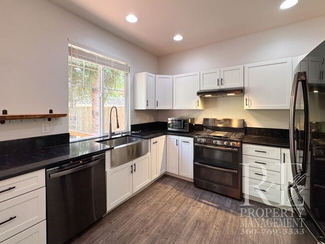 Building Photo - Dual Primary Suites, Huge Backyard Deck & Sun-Filled Living Spaces Near Everyday Conveniences