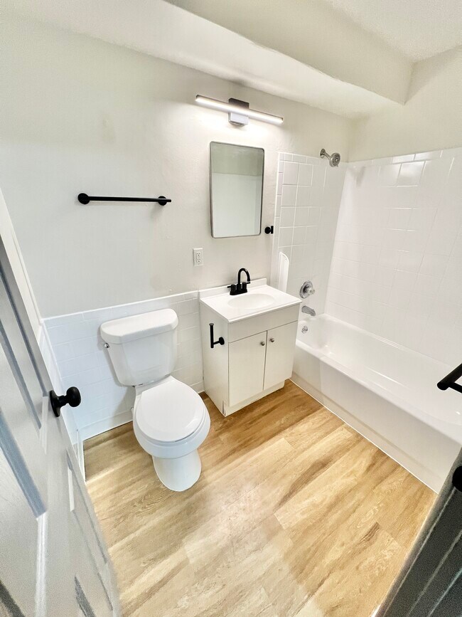 Experience the serenity of a modern bathroom with stylish fixtures and a calming aesthetic. - Melody Apartments
