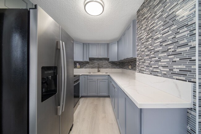 Building Photo - Upgraded Fully Furnished Condo w/ Assigned...