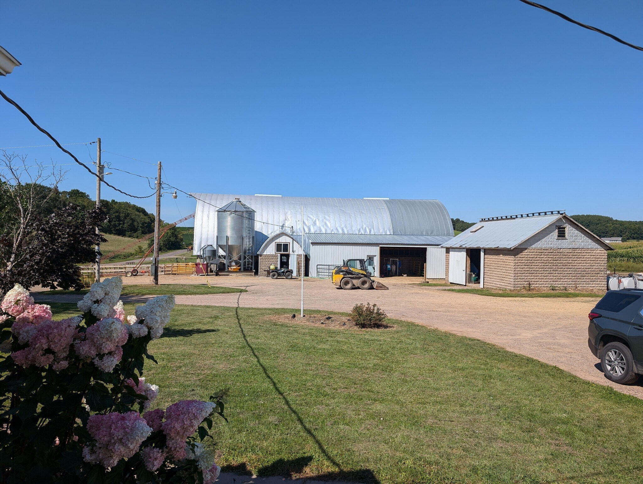 View from house of farm buildins, shared driveway with working farm - E9461 945th Ave