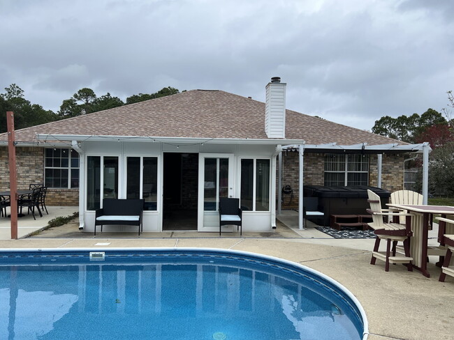 Building Photo - 4-Bedroom Home with Sunroom, Pool and Hot ...