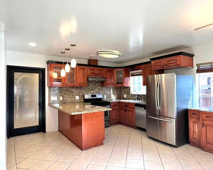 Kitchen from main entrance showing doored entrance to living area. - 2330 S Mansfield Ave