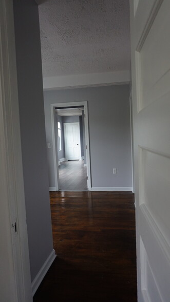 entering through the living room to the kitchen, you can see the bedroom in the back - 129 N Main St