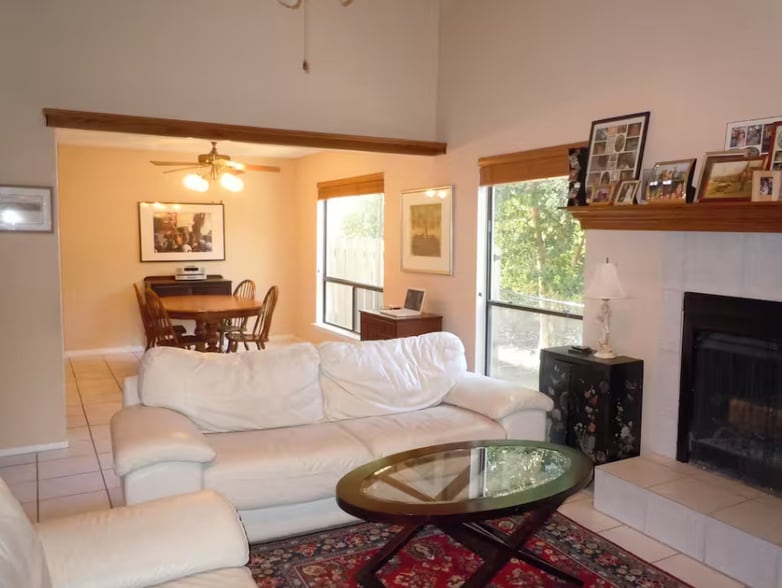 Living room has high ceiling with tons of natural light, gas fireplace, built-in bookcase - 6806 Thorncliffe Dr