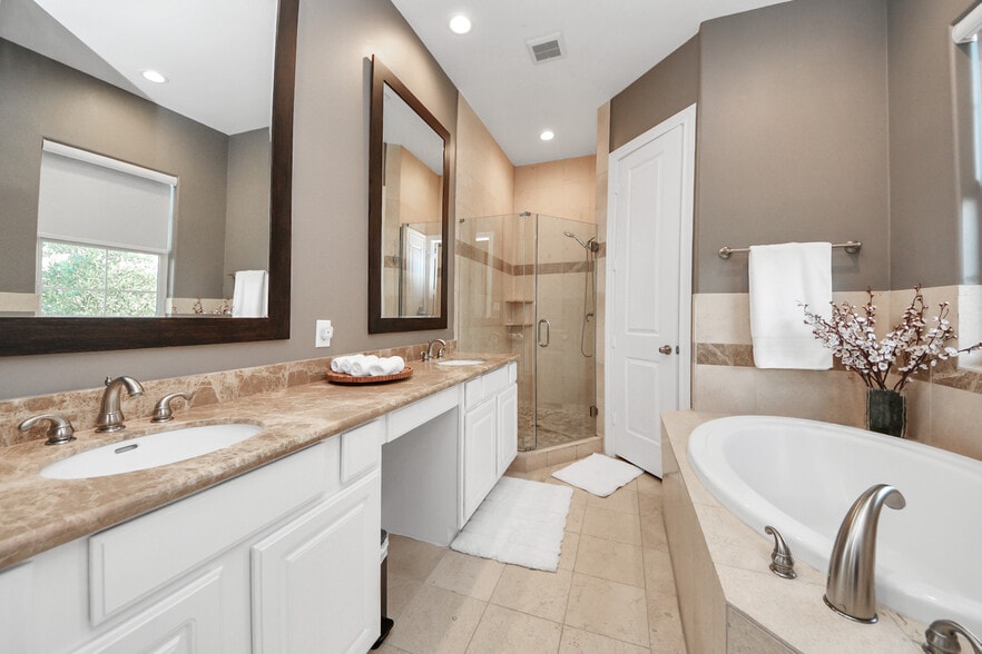A marble-topped double vanity and soaking tub evoke hotel-suite indulgence. - 620 Rutland St