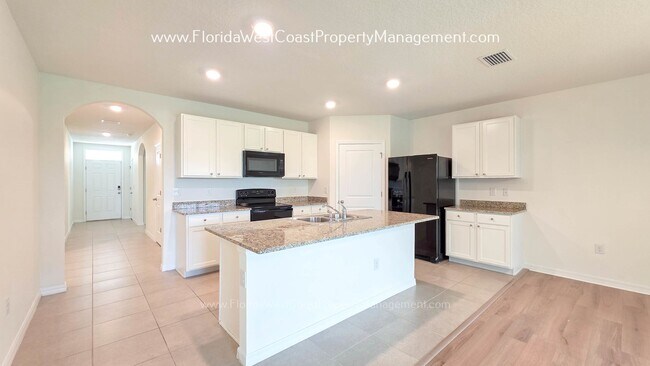 Building Photo - MOVE IN READY ! 4 BEDROOM/2 BATH! TILE- LVP THROUGHOUT! LAWN MOWING INCLUDED!
