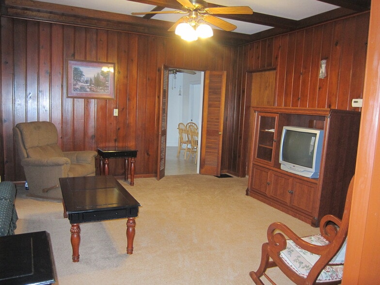 View of the family room looking towards the kitchen and bedroom #2. Beautiful wood finished walls and ceiling fan. - 1445 South Center Street