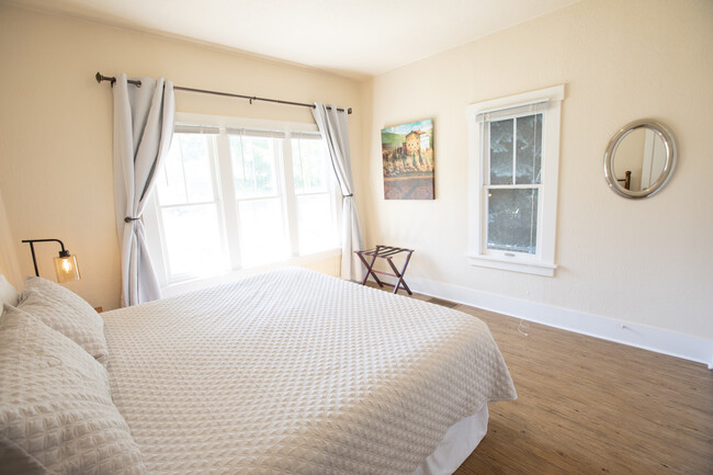 Downstairs master bedroom with King size bed. Blackout curtains and large closet. - 717 E Lakeside Ave