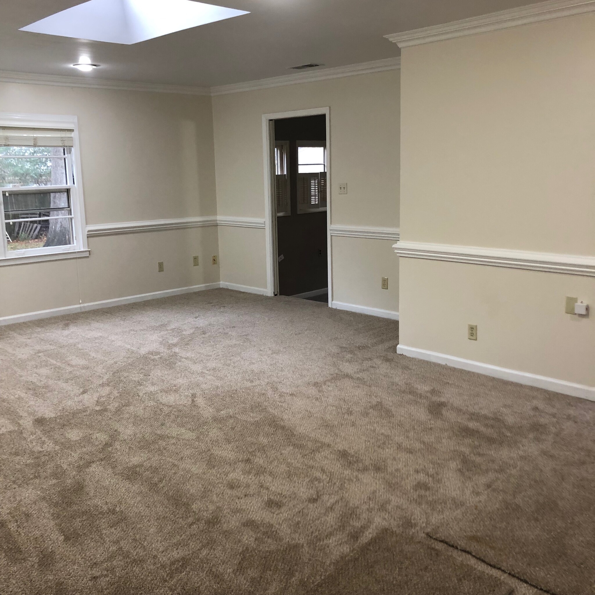 Large family room looking side to the sunken den/dining room, ceiling skylight shown. - 4968 New Haven Ave