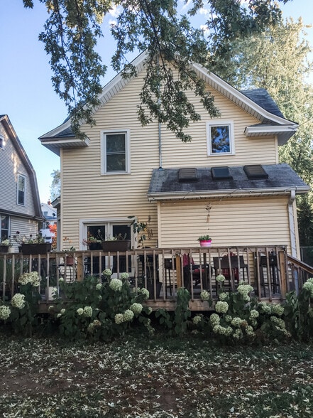 Backyard with large deck and mature perennials (hydrangea, lilac, roses, herbs, and more!) - 819 Edmund Ave
