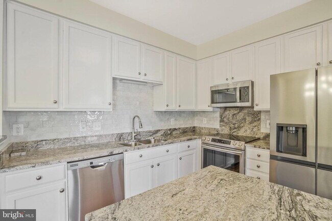 Building Photo - This beautifully maintained brick-front, three-level townhome is located in a highly sought-after...