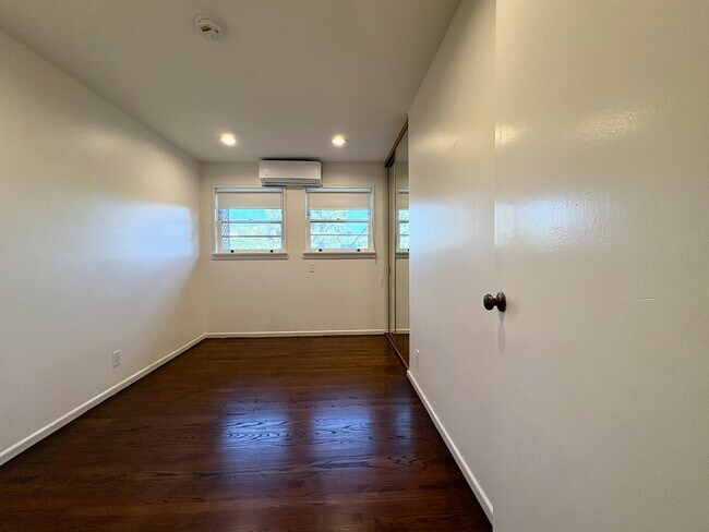 Second bedroom featuring split AC and mirrored closet. - 1672 Rotary Dr