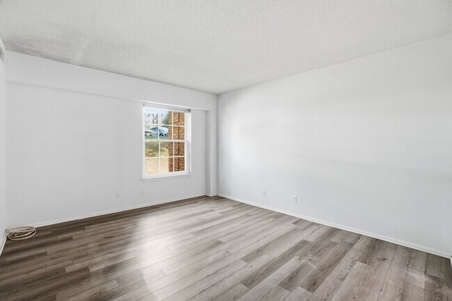 Building Photo - This expansive ground level residence is set within a serene, gated garden community surrounded b...