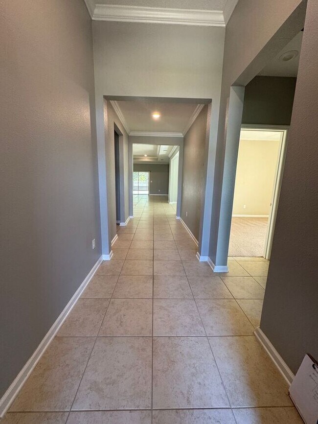 Building Photo - COMING SOON! Beautiful 4BR 3BA Home w/ Screened Lanai & Pond View • Garage Parking • Fenced Yard ...